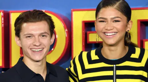 Getty Images A close-up of Tom Holland and Zendaya together promoting Spider-Man: Homecoming in 2017. They both have big smiles on their faces.