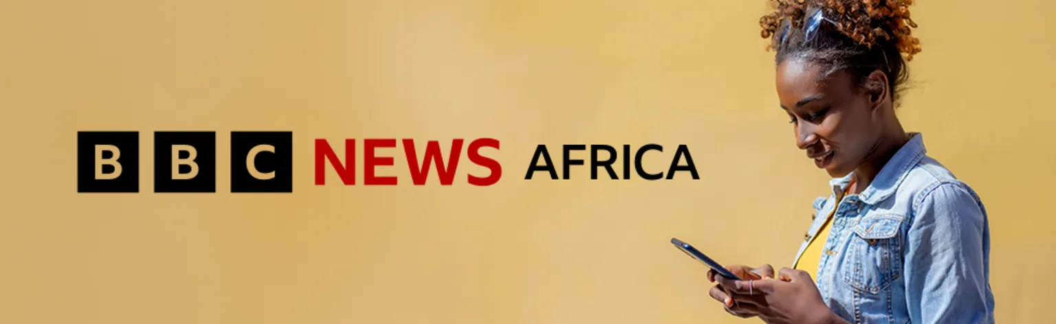 To the right of the banner a woman with sunglasses on her head and wearing a denim jacket and yellow T-shirt looks down at her mobile phone. A graphic for BBC News Africa in black and red is on the left of the image which has a pale golden brown background.