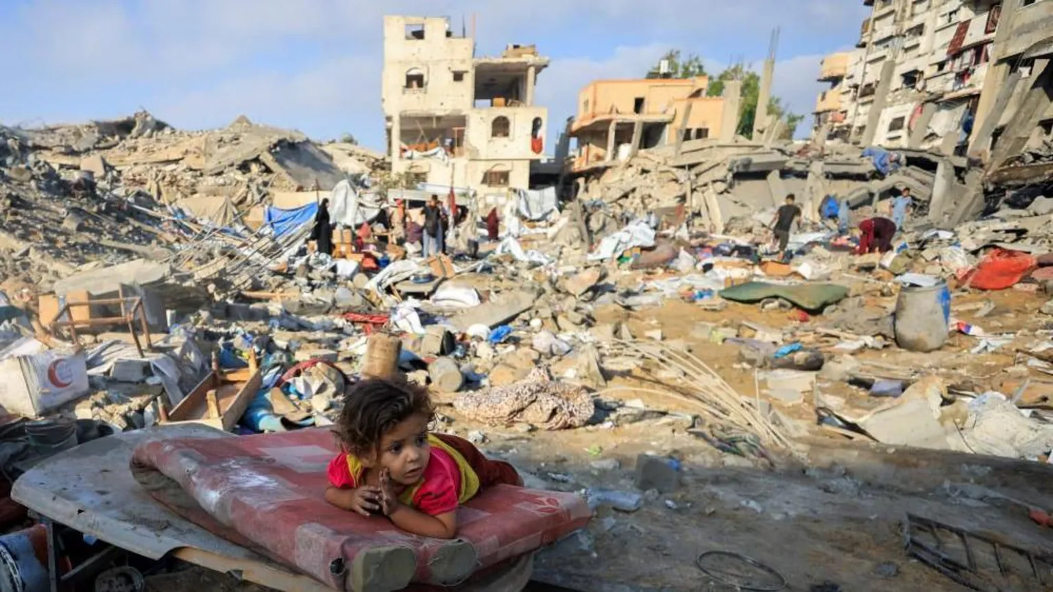 Reuters A Palestinian girl child lies on a damaged mattress in Gaza City