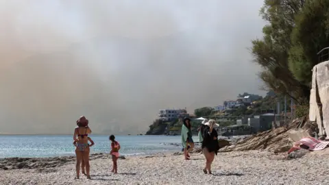 Smoke fills the sky as a fire burns through mixed agricultural and forest land in Plomari, Lesvos, Greece, 29 July 2026