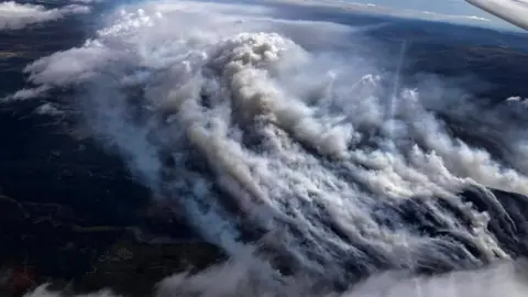 An image taken from a glider showing thick smoke rising from the wildfire in the Cairngorms.
