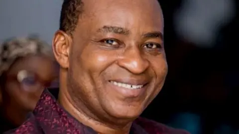 Bernard Antwi Boasiako smiles at the camera in a close up shot.