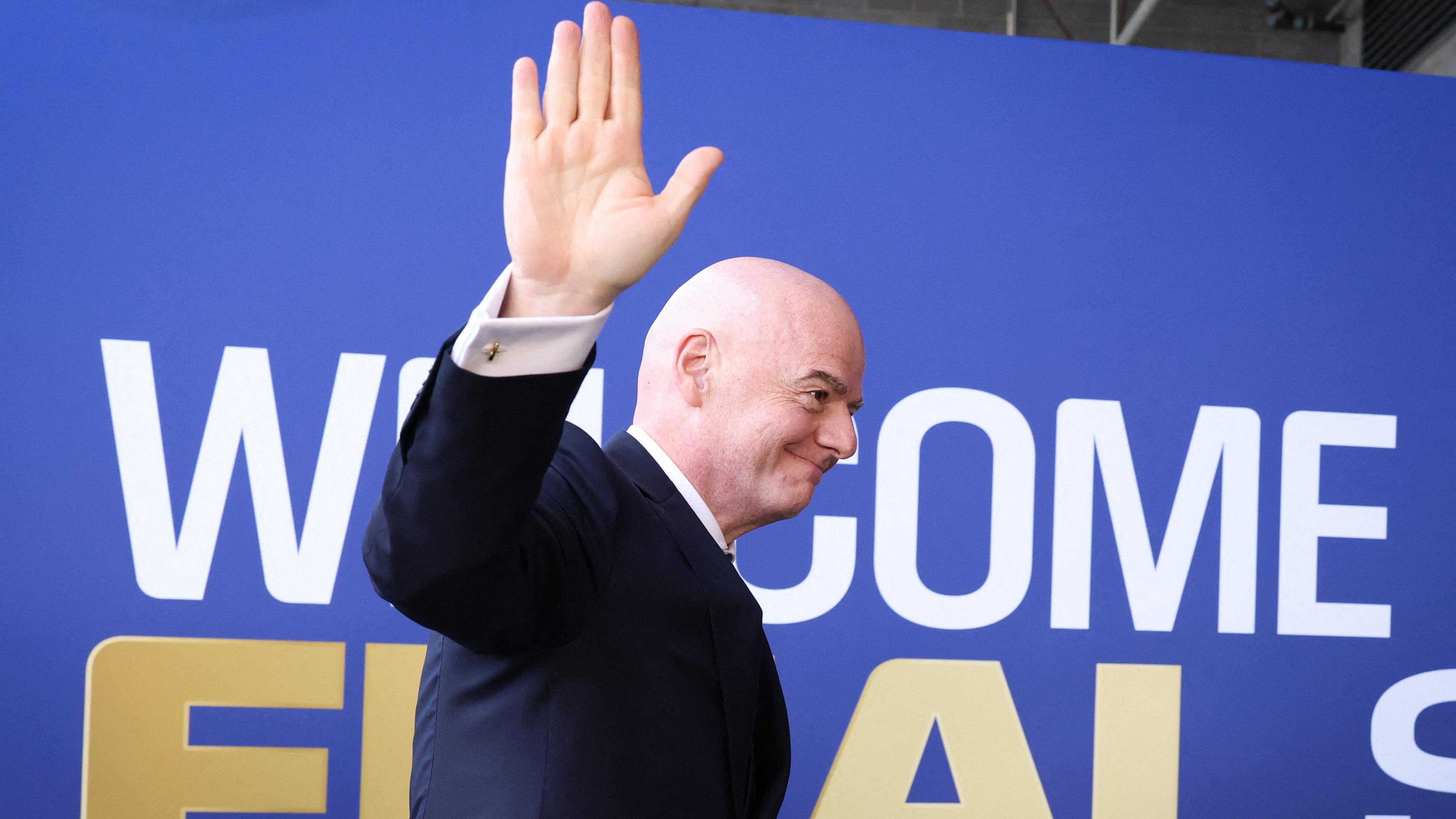Fifa president Gianni Infantino waves while walking