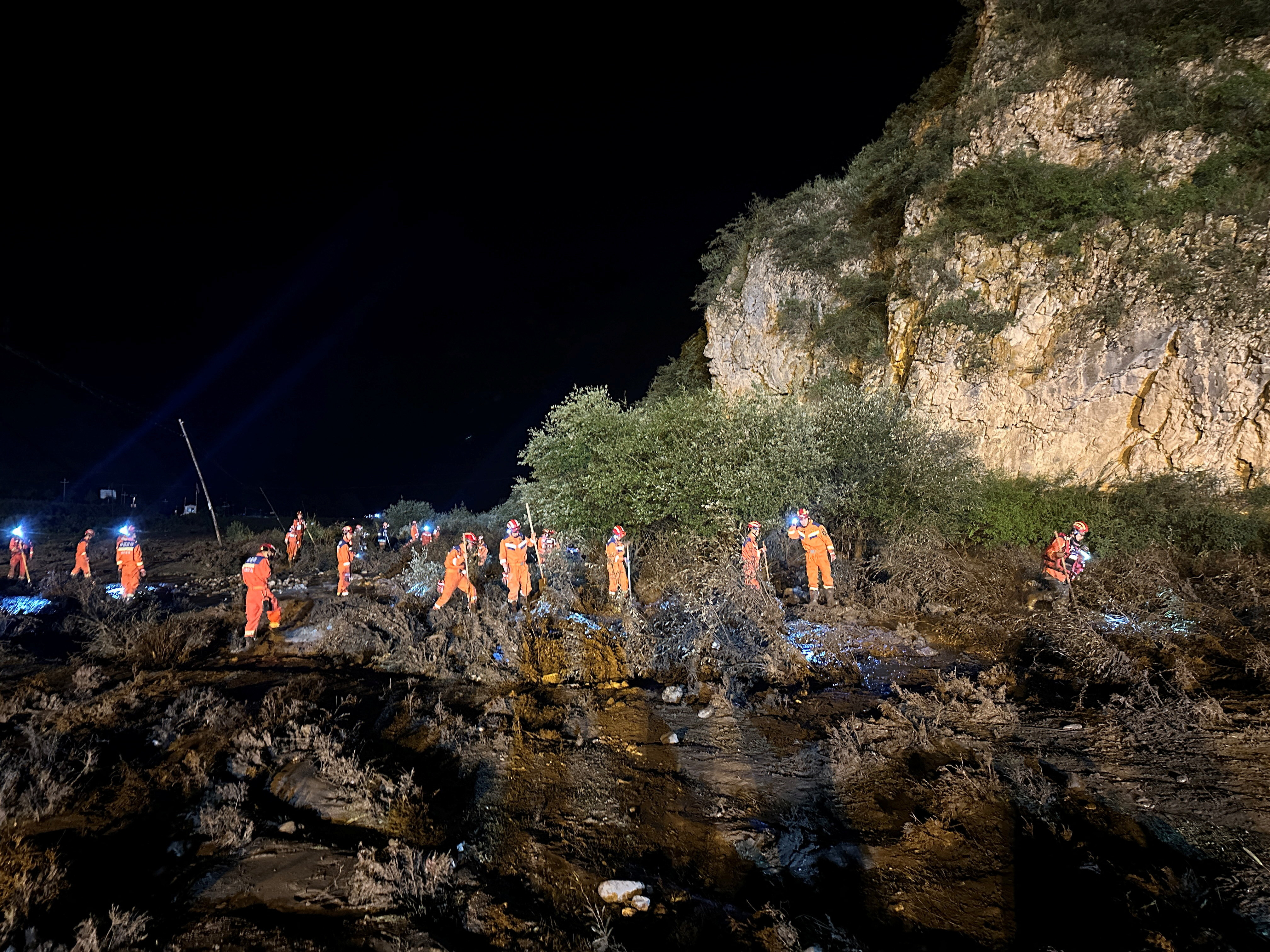 Rescue workers carry out search and rescue operations following flash floods at a scenic area in Weiyuan