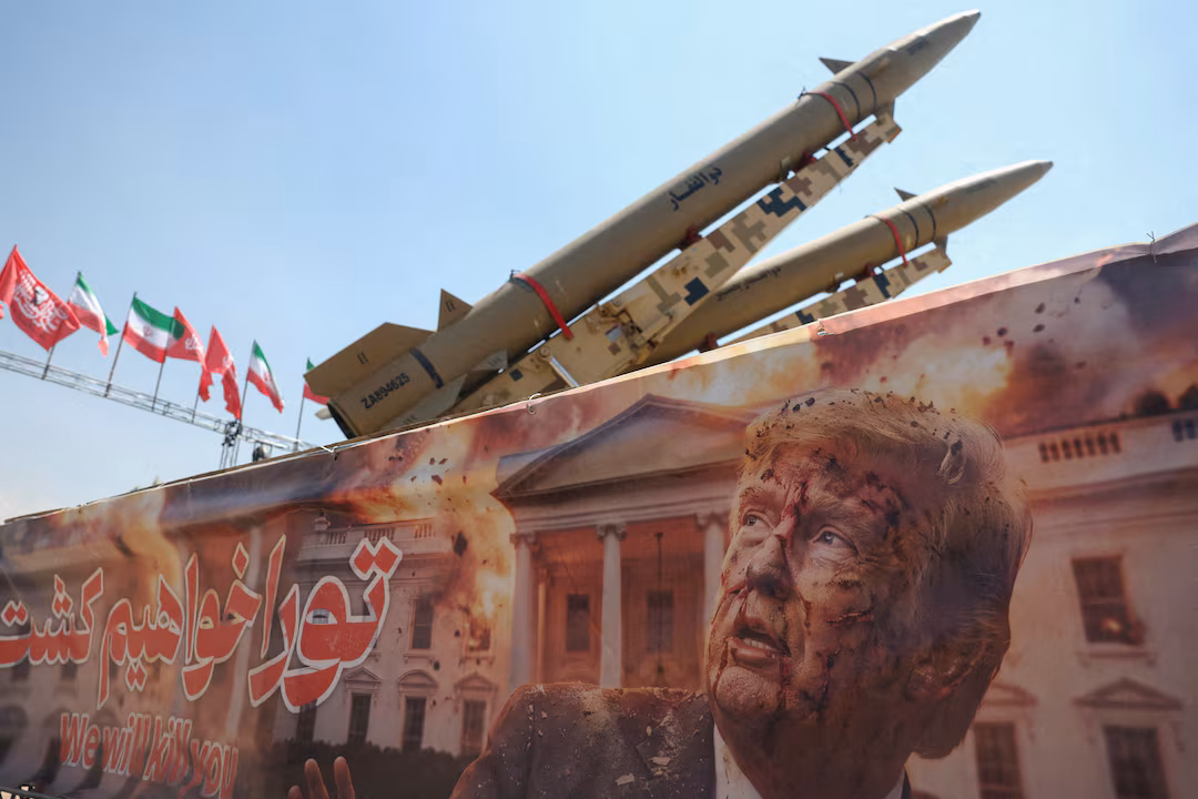 A banner with a picture of U.S. President Donald Trump next to an Iranian missile system at Azadi Square in Tehran