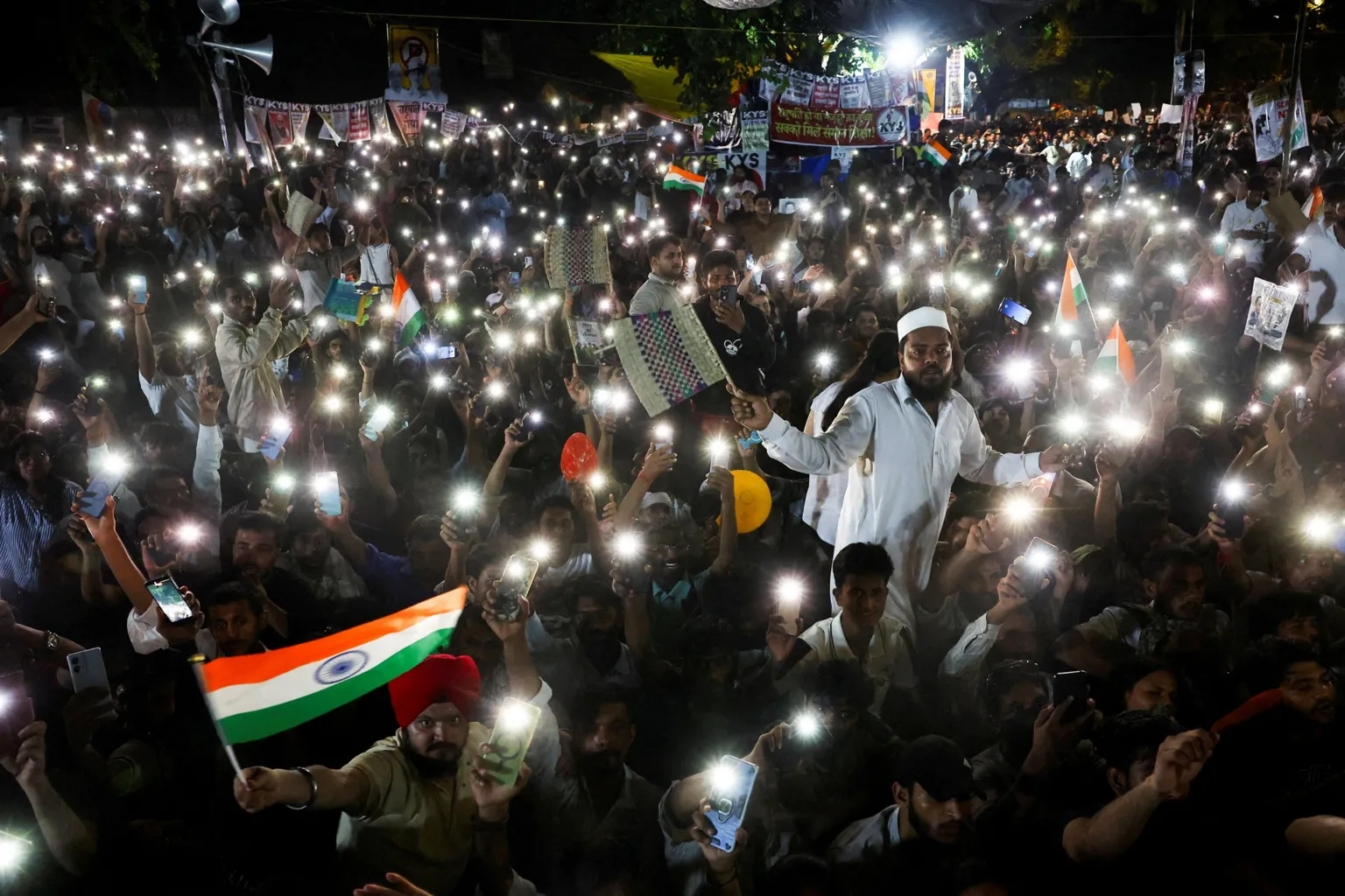 Reuters Supporters of the Cockroach Janta Party (CJP) chant slogans and wave their mobile phones with torches on as they gather after Indian education activist Sonam Wangchuk, who had been on a hunger strike, was taken to a hospital by authorities on Saturday during a sit-in protest demanding the resignation of Indian Education Minister Dharmendra Pradhan